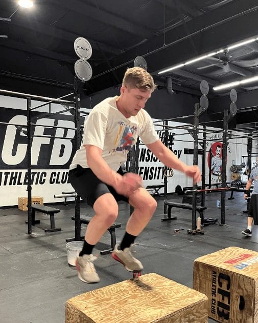 Athlete performing box jump exercise during functional training at CFB Athletic Club